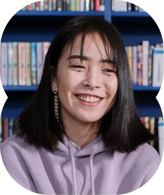 Creator in front of a bookshelf